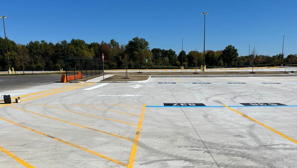 close-up of freshly painted yellow line markings for Amazon parking lot