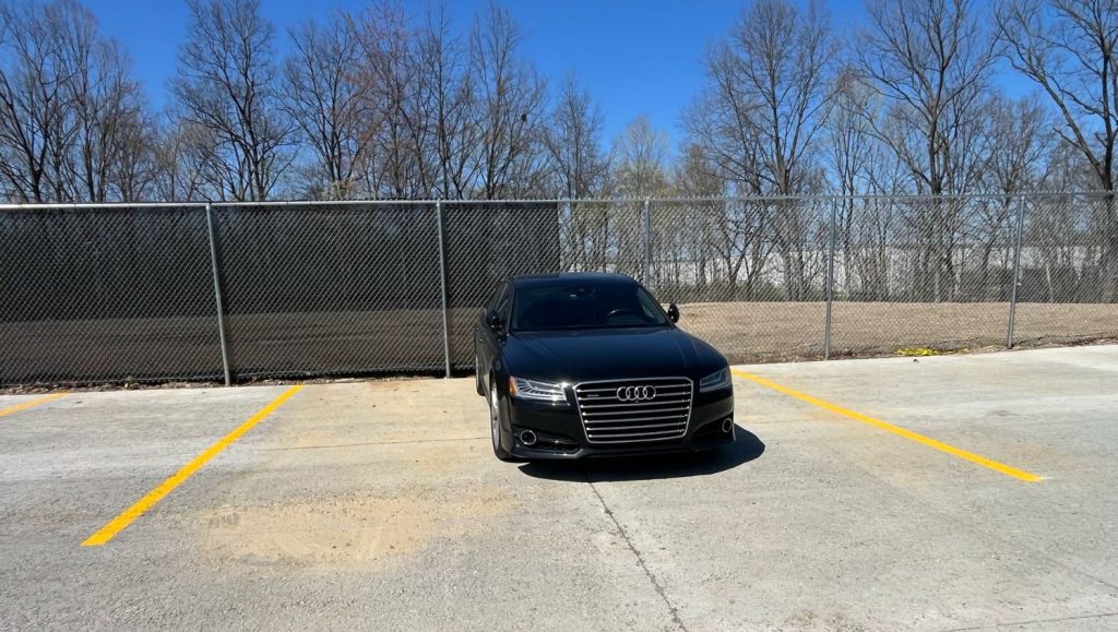 car parking in between new freshly painted parking spot