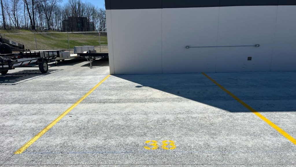 yellow line striping for Burns & Scalo parking lot freshly painted