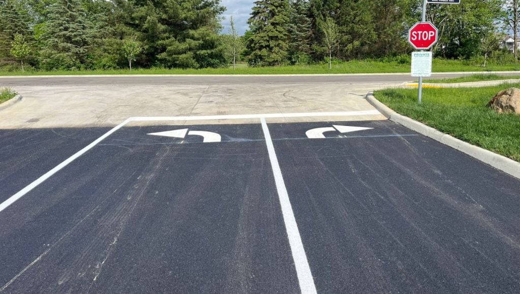 freshly painted white arrows for Orange Summit Apartments parking lot
