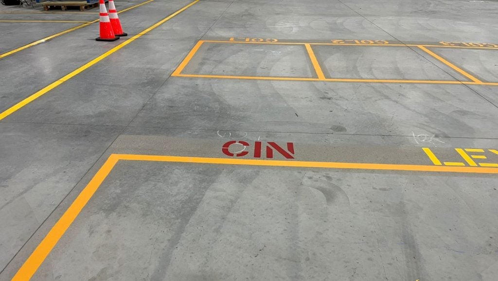 close-up of warehouse floor markings freshly painted