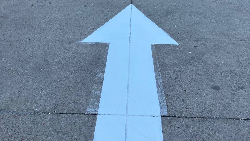 close-up of freshly painted white arrow