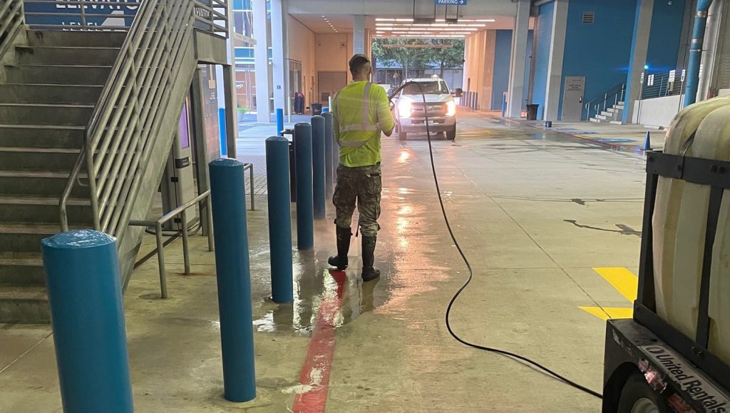 close-up of G-FORCE® employee pour washing The Shops at Legacy West parking lot