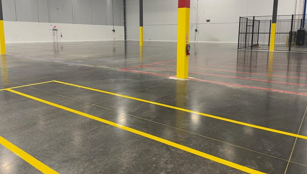 close-up of two yellow line markings freshly painted for Pratt & Whitney warehouse