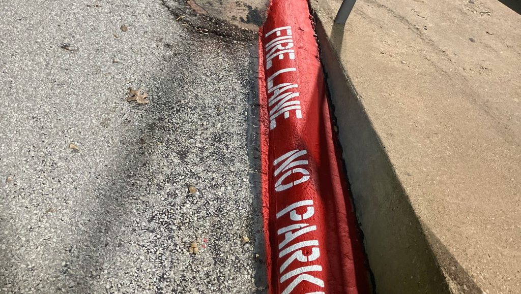 close-up of fire lane striping freshly painted for Airborne Inc parking lot