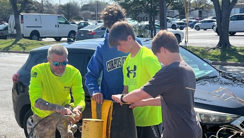 Eagle Scouts helping G-FORCE® paint their parking lot