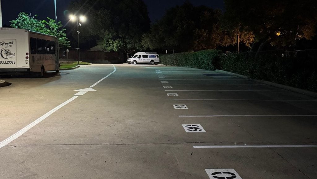 parking spots freshly painted for Dallas Academy parking lot at dusk