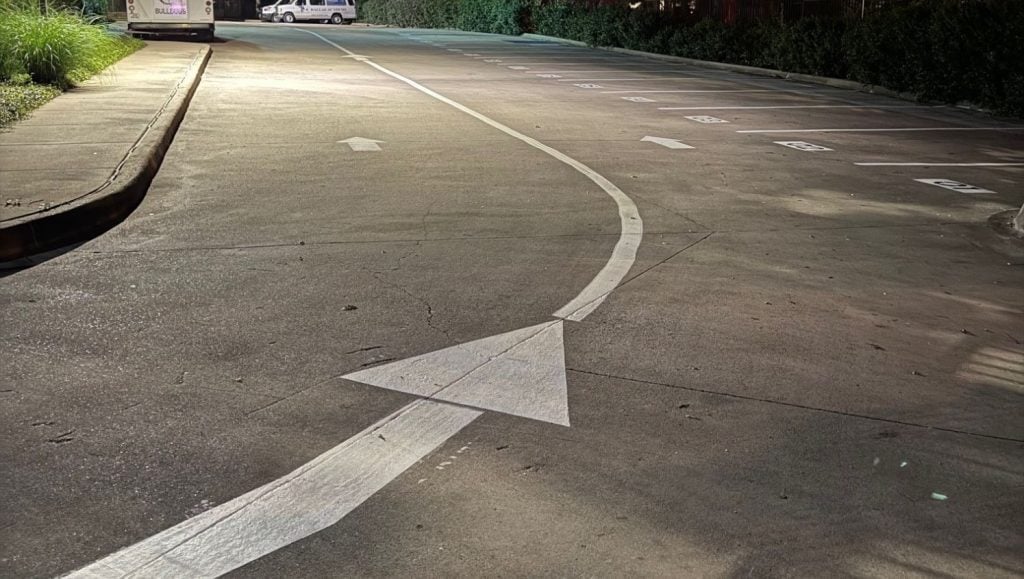 close-up of white arrow freshly painted for Dallas Academy parking lot