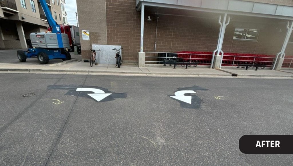 two white freshly painted arrows for Trader Joe's parking lot