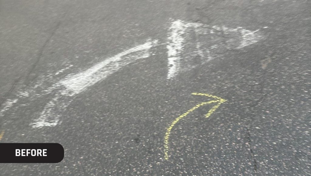 faded arrow on Trader Joe's parking lot close-up