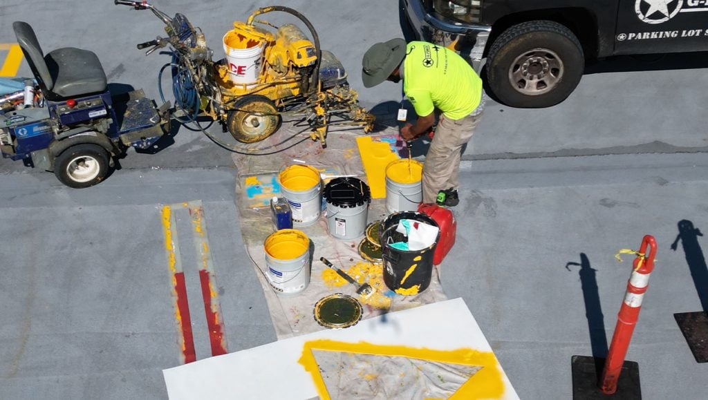 Ford Field Parking Garage parking lot freshly painted with G-FORCE® employee on machine