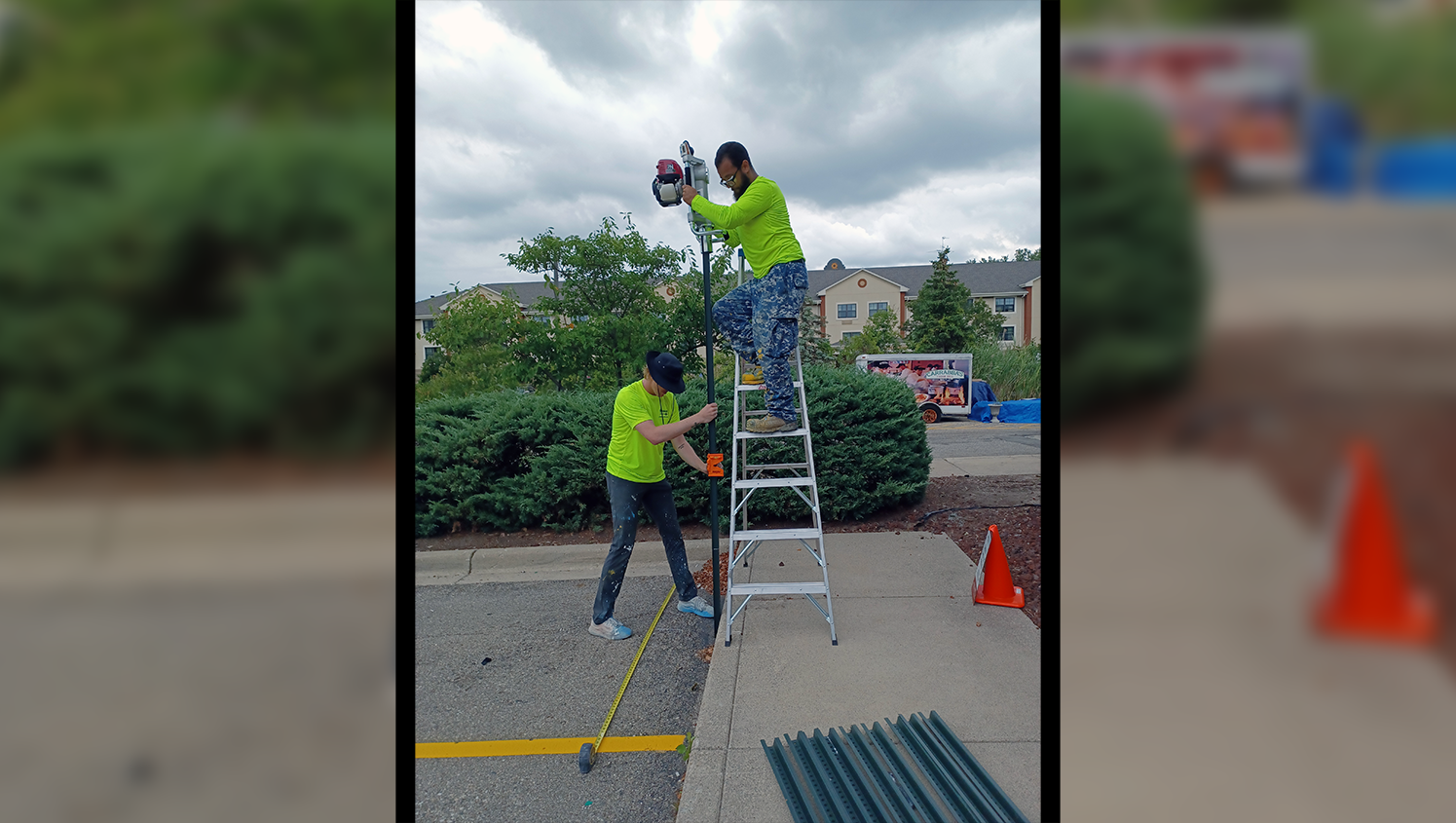 worker on ladder measuring pavement