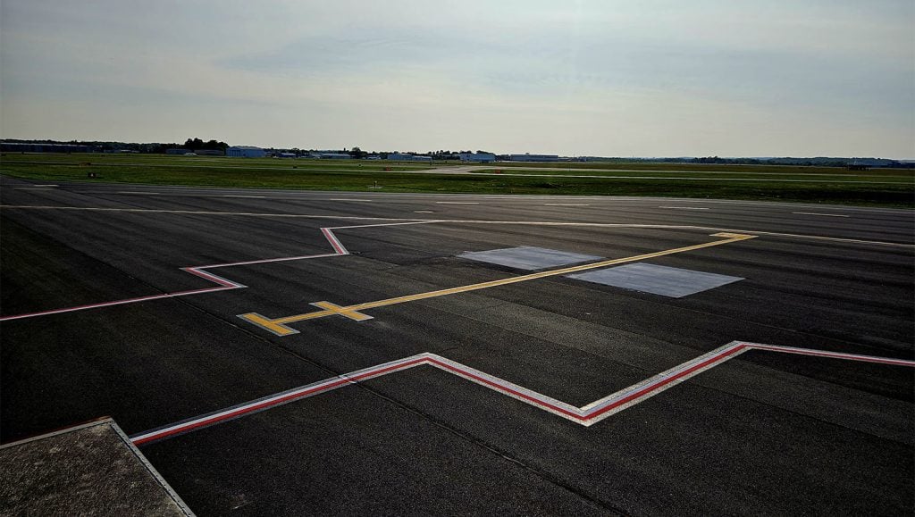 employee striping airport markings