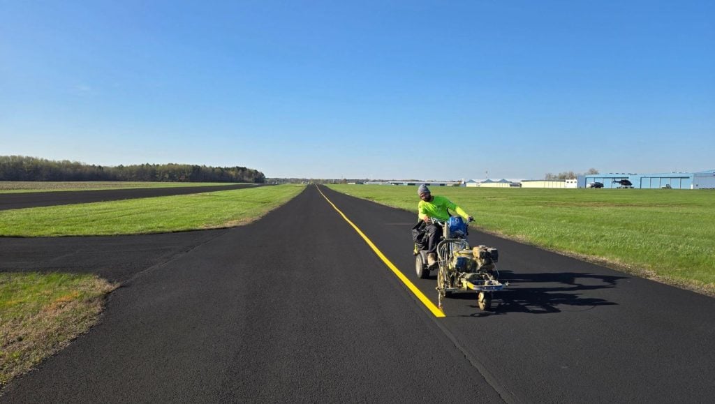 G-FORCE® employee painting lines on Summit Avation runway