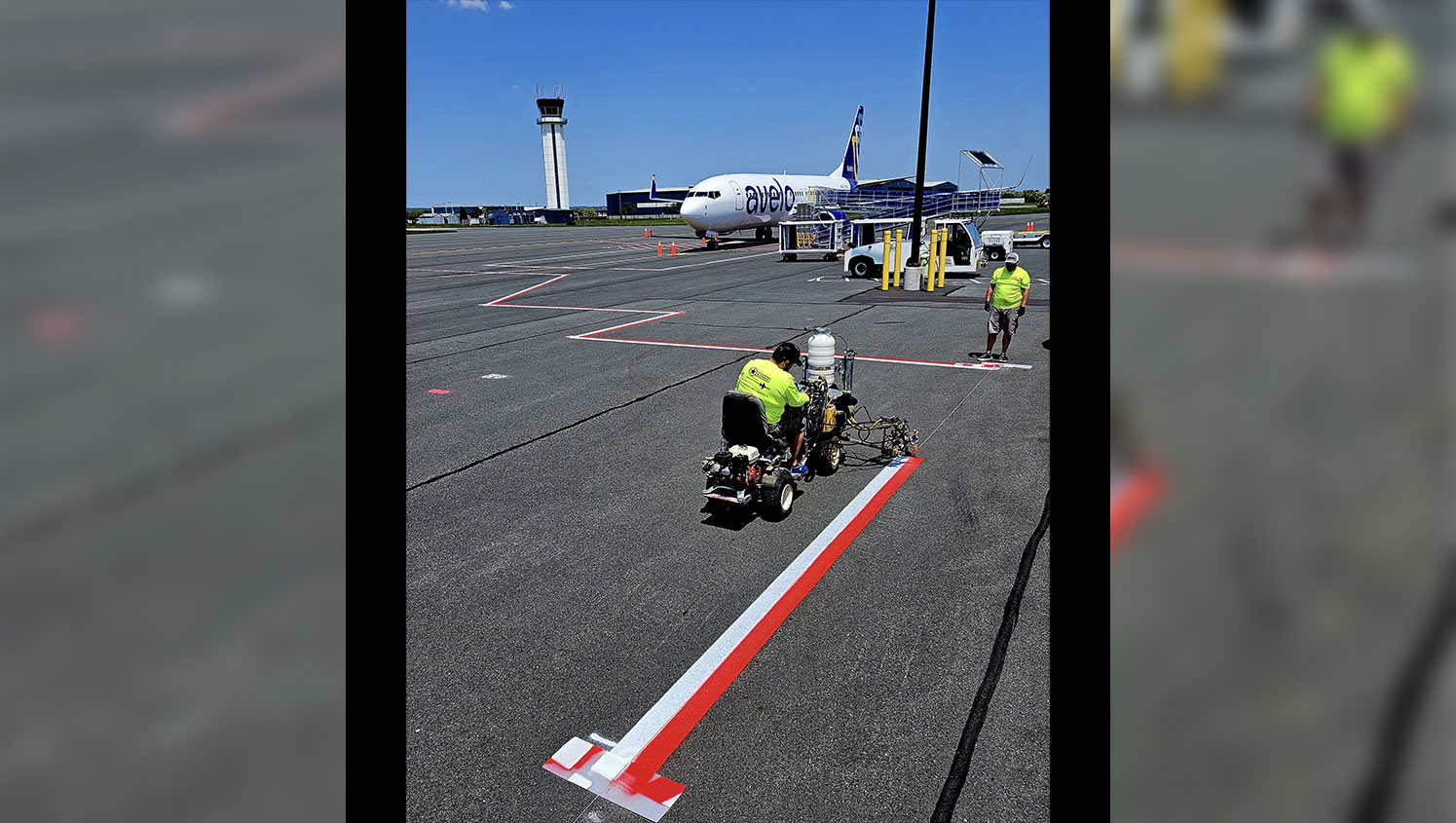employee striping airport markings
