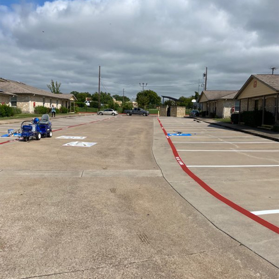 side view of freshly painted parking lot at Red Oak Apartments