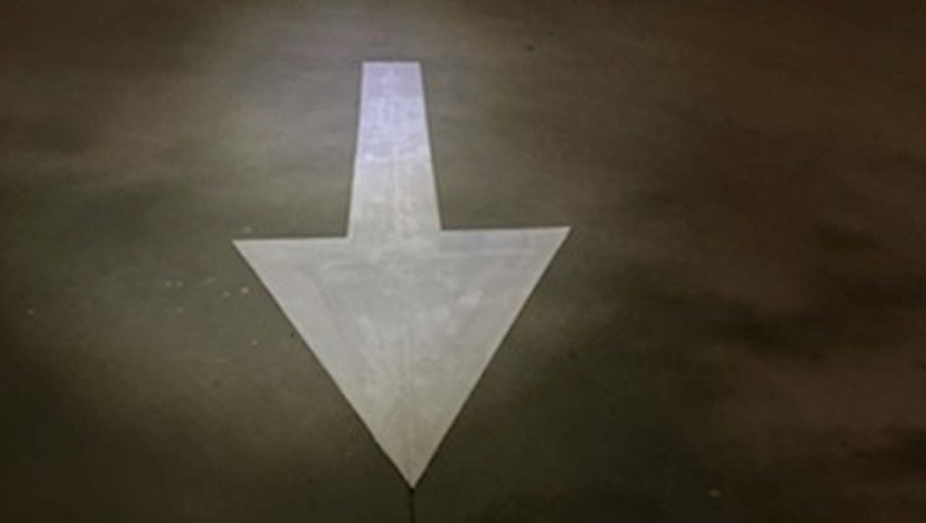 close-up of a freshly painted arrow for Burleson Commons Shopping Center parking lot