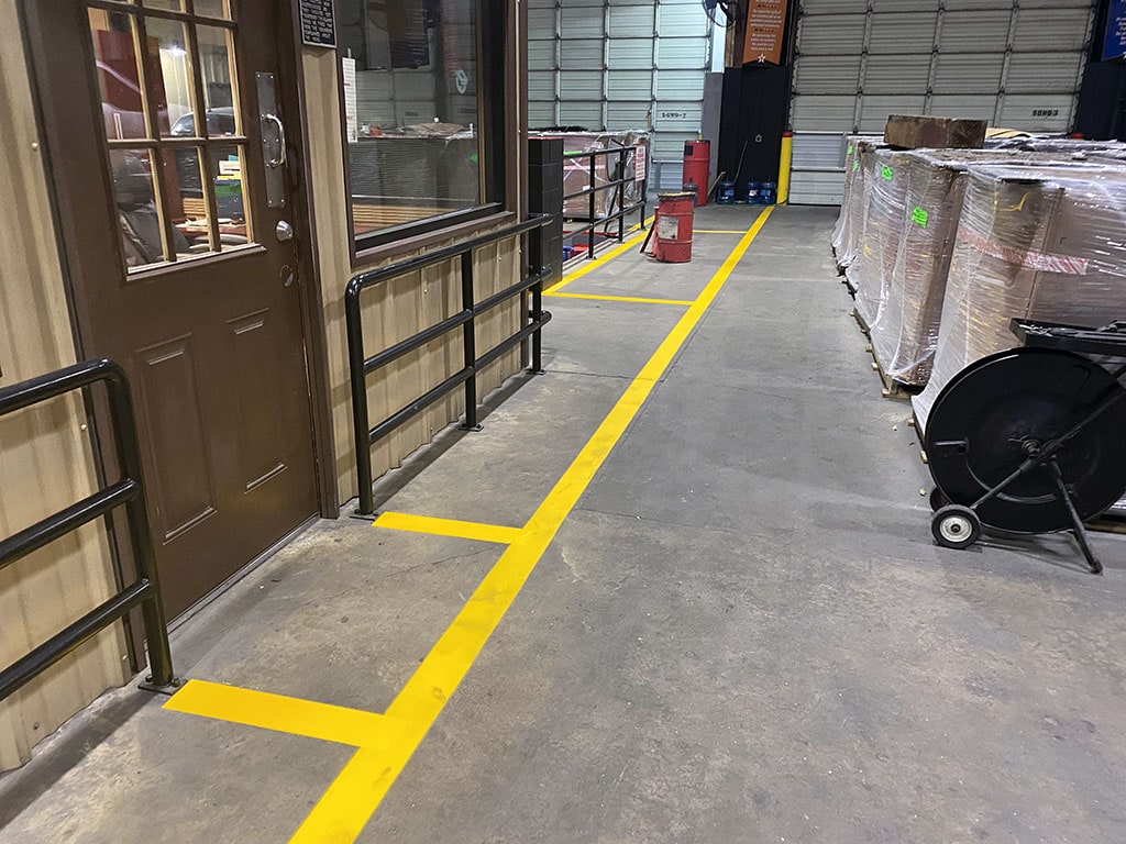 new yellow floor striping placed inside Snelson Services