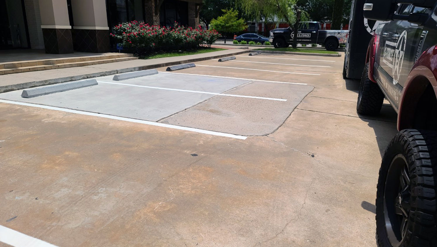recently applied parking lot lines and wheel stops at the West Gray Center of Surgery in Houston, TX
