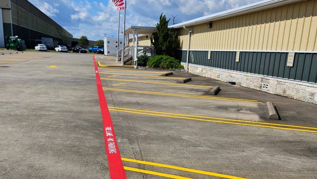 close-up of fire lane striping markings freshly painted for Parkline, Inc. parking lot