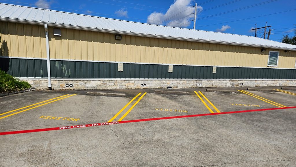 freshly painted parking spots and fire lane markings for Parkline, Inc. parking lot