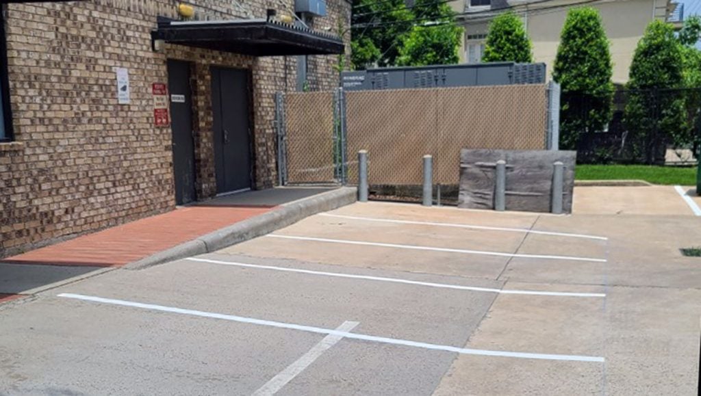 recently applied parking lot lines and wheel stops at the West Gray Center of Surgery in Houston, TX