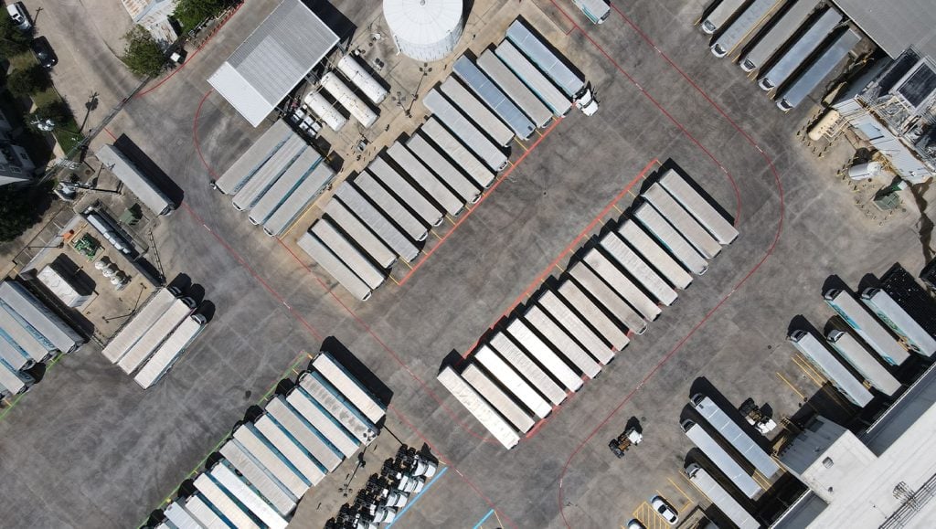 aerial view of trucks at truck yard at oak farms