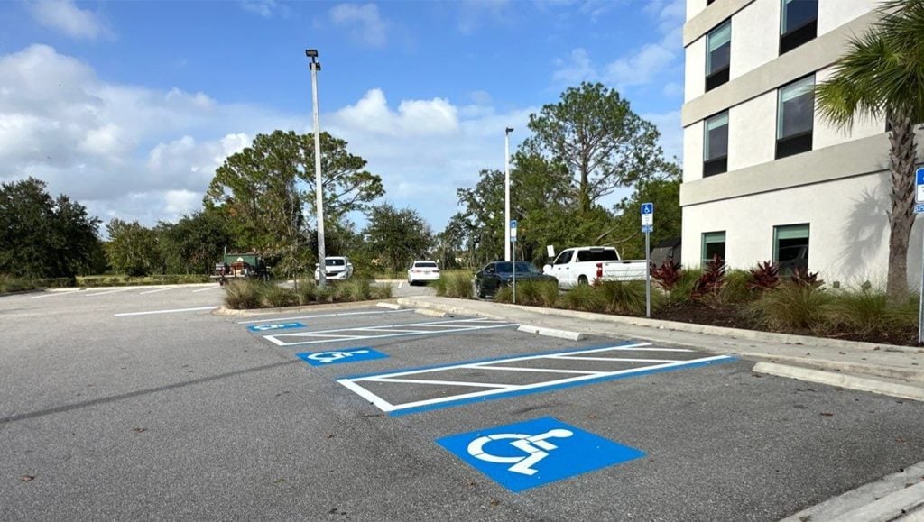 ev charging bay markings freshly painted for Home 2 Suites parking lot
