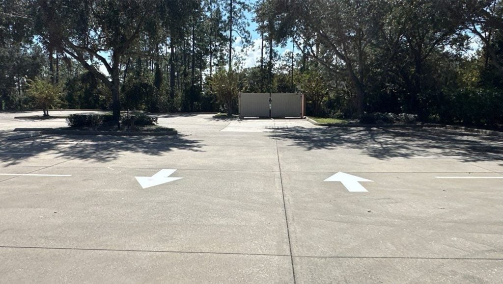 freshly painted white arrows for Aza Health Plaz pavement