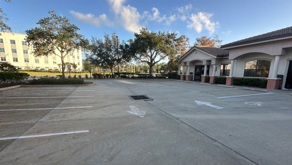 Aza Health Plaz parking lot with faded line markings