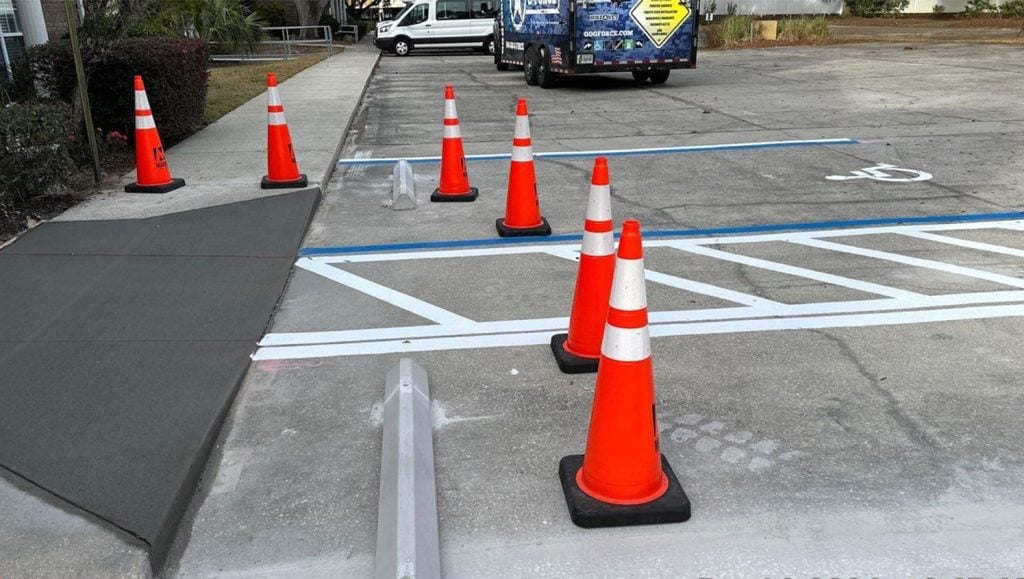 close-up of freshly painted line markings and cones for Marand Builders and Brooks Rehabilitation parking lot
