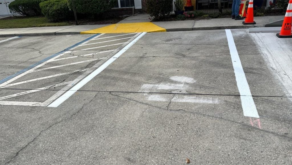 freshly painted parking spot close-up for Marand Builders and Brooks Rehabilitation parking lot
