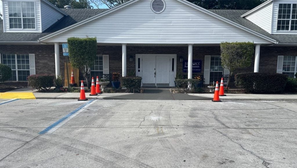 front view of Marand Builders and Brooks Rehabilitation parking lot with freshly painted parking spots