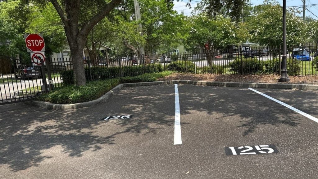 parking spots freshly painted for The John Gorrie Condominiums parking lot