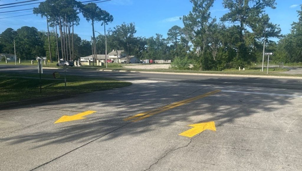 freshly painted yellow arrows for Advanced Auto Parts parking lot