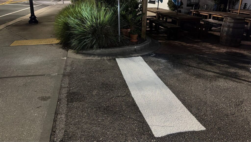 white line striping freshly painted for V's Pizza parking lot