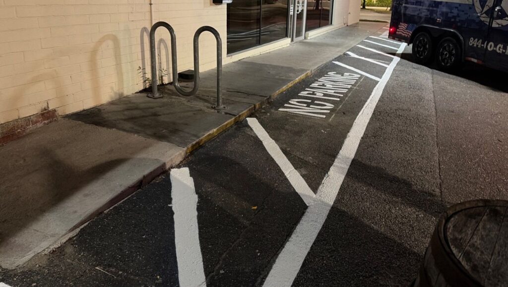 line markings freshly painted for V's Pizza parking lot