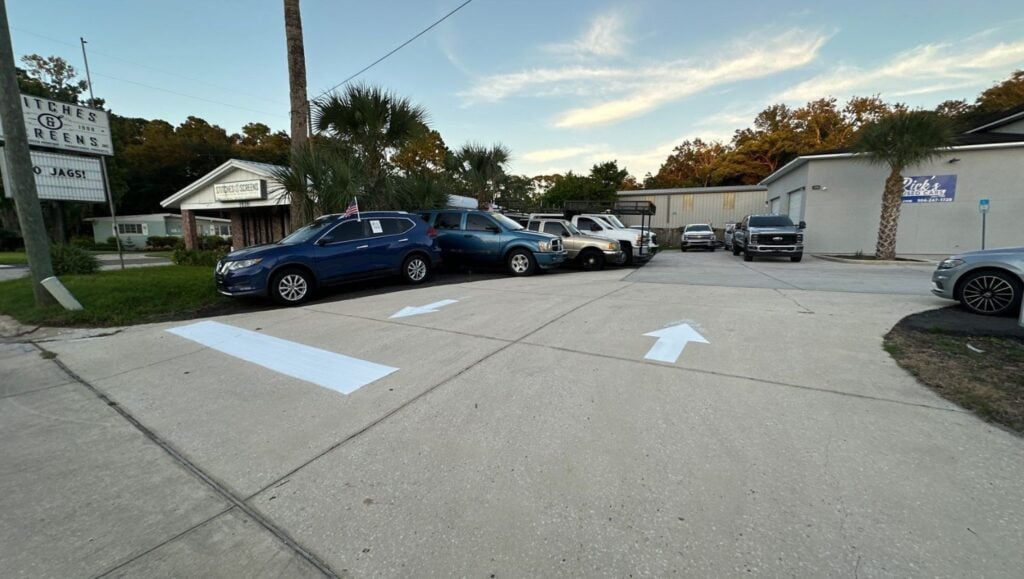 line markings freshly painted for Rick's Used Cars parking lot