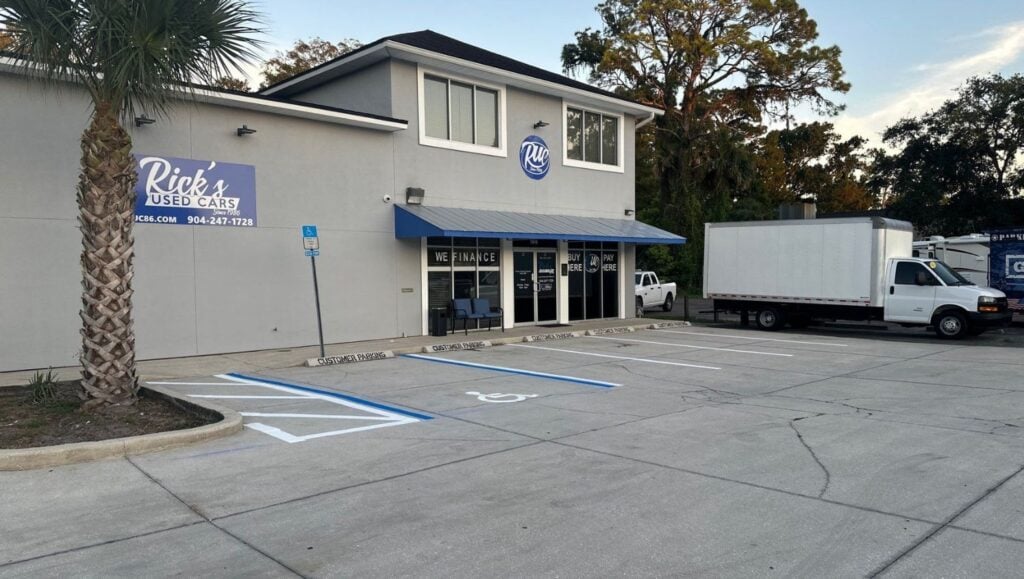 Rick's Used Cars parking lot with freshly painted ada compliance parking spots
