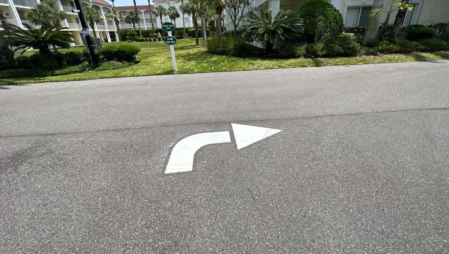 a curved arrow painted on the street