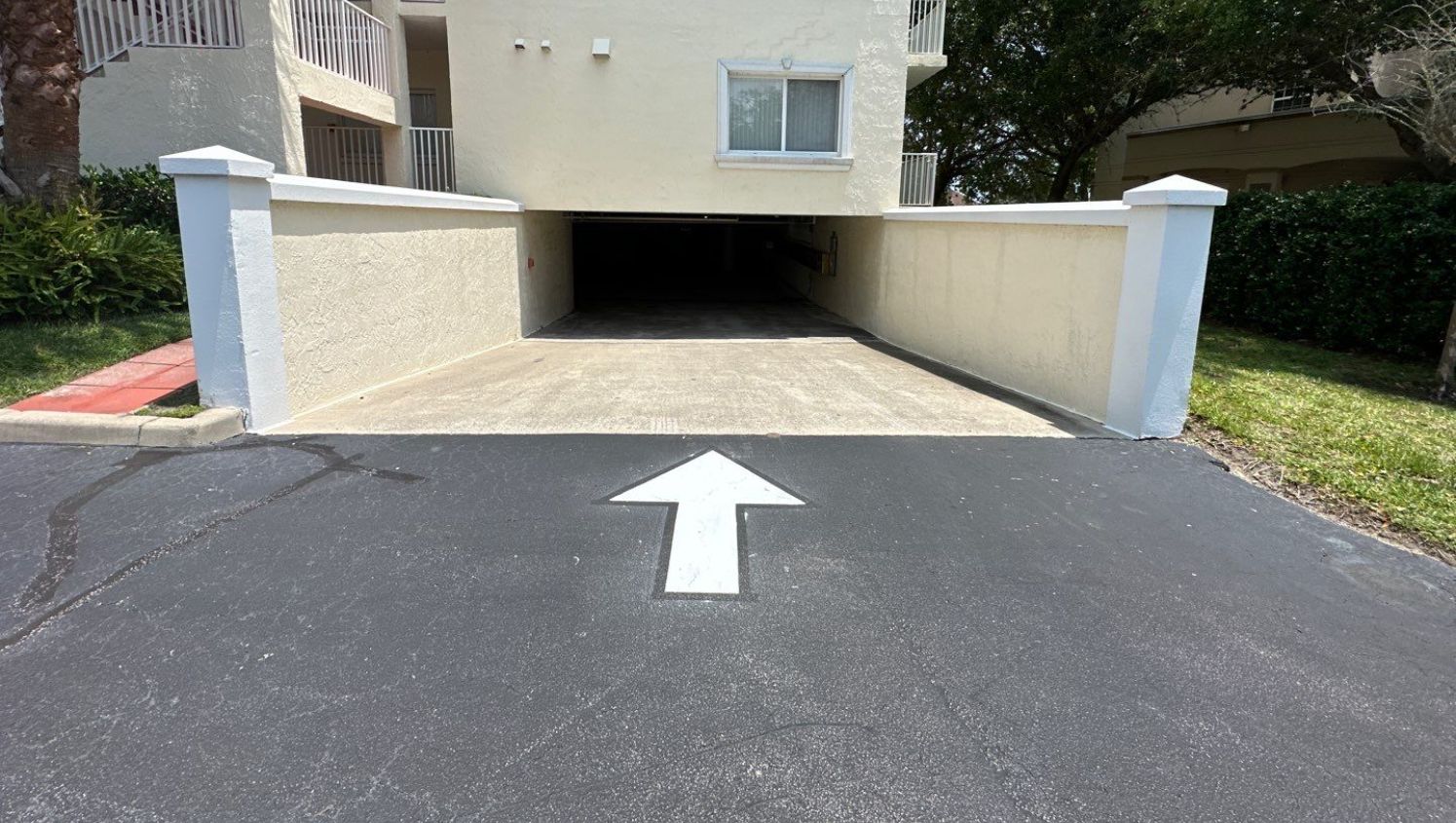 an arrow on the street pointing to a garage
