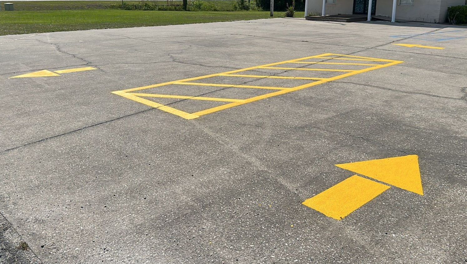 yellow directional arrows and hashes on the lot