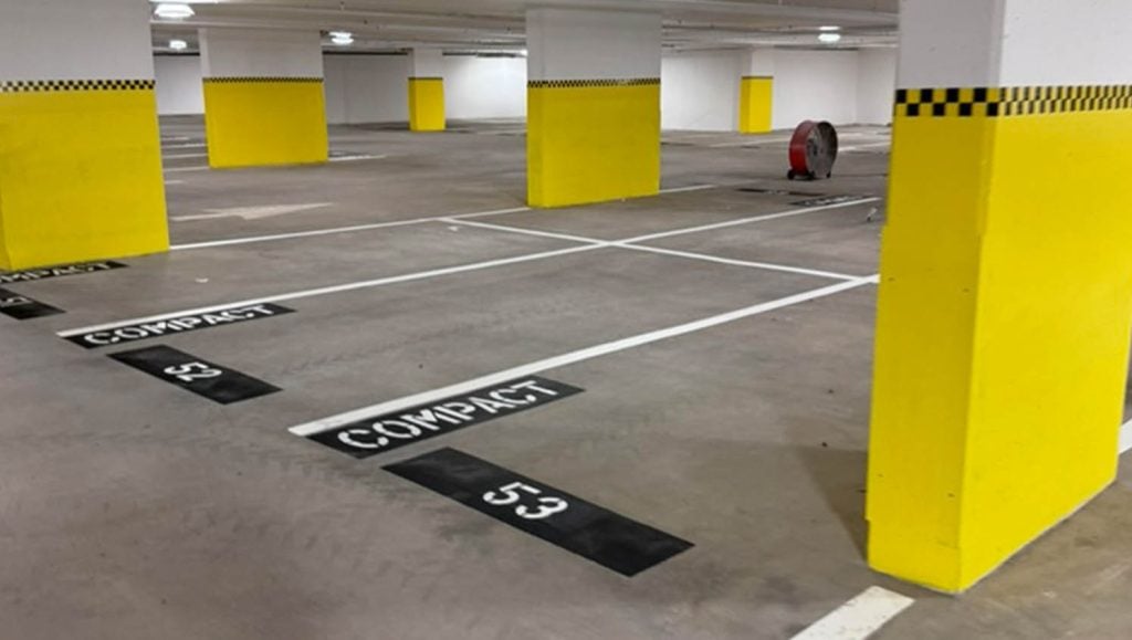 compact parking spots freshly painted for Marriott Vacation Club and Hotel Waikiki parking garage