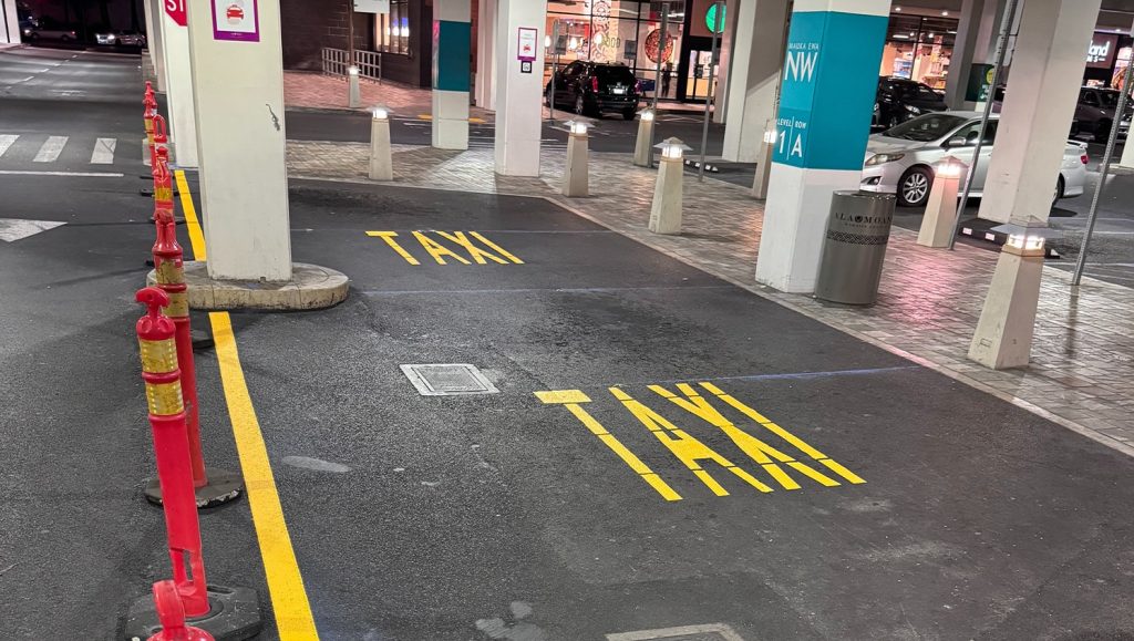 close-up of "taxi" painted on Ala Moana Shopping Center parking lot