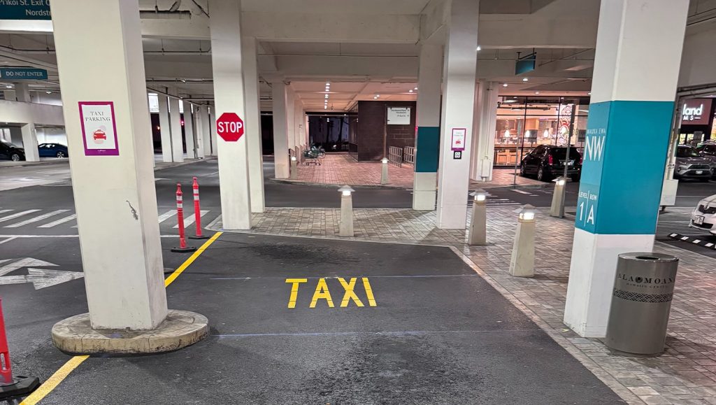 close-up of "taxi" freshly painted on Ala Moana Shopping Center parking lot