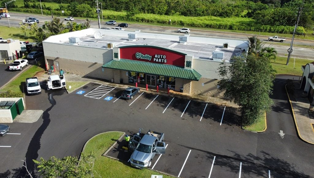 aerial view of auto parts store parking lot with fresh line markings