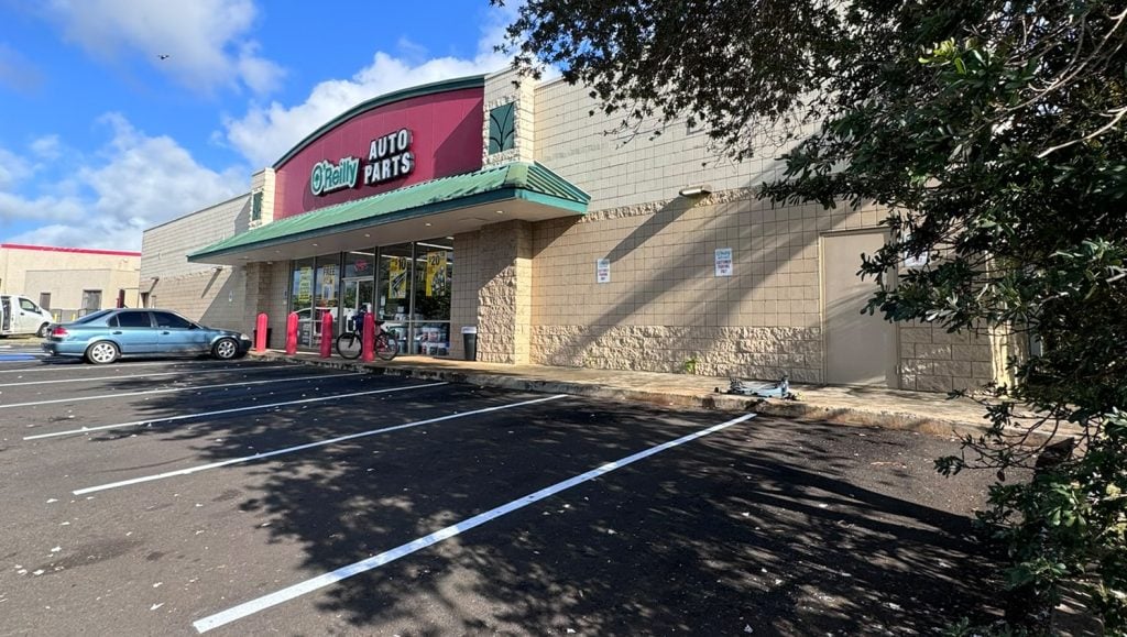 aerial view of auto parts store parking lot with freshly painted line markings