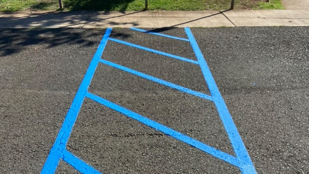 blue ada compliance cross walk markings freshly painted