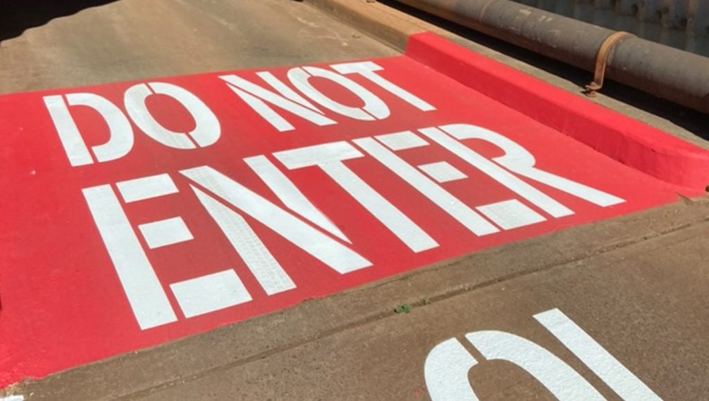 do not enter freshly painted for Coral Creek Golf Course parking lot