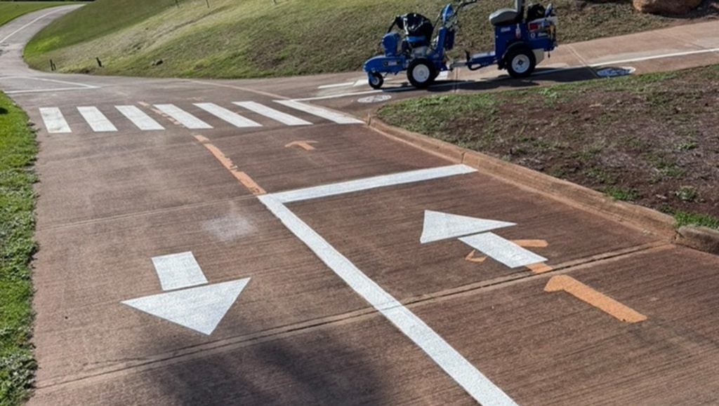 freshly painted white arrows for Coral Creek Golf Course parking lot